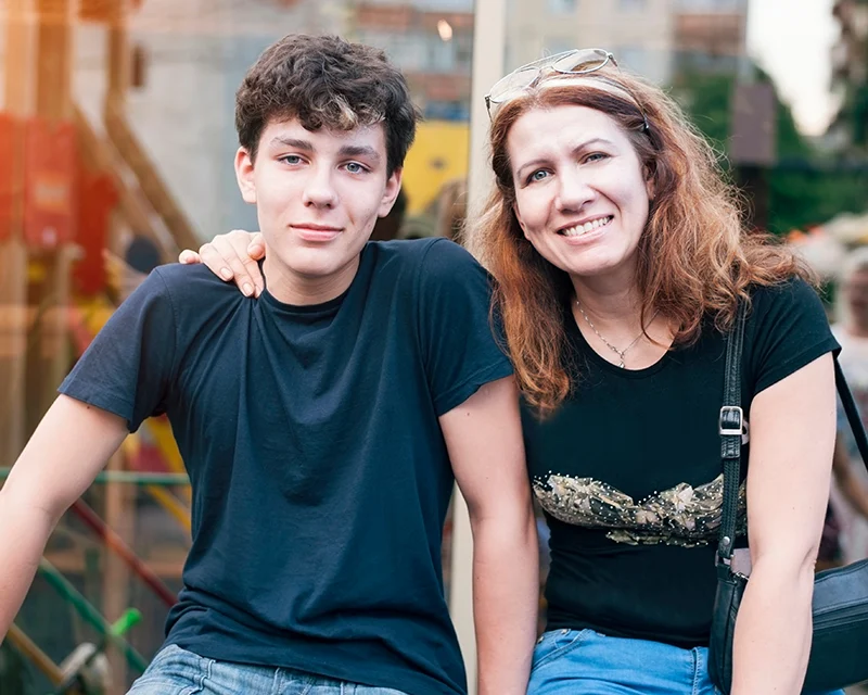 a mother and son sit together