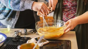 teens mixing batter in a bowl on a countertop